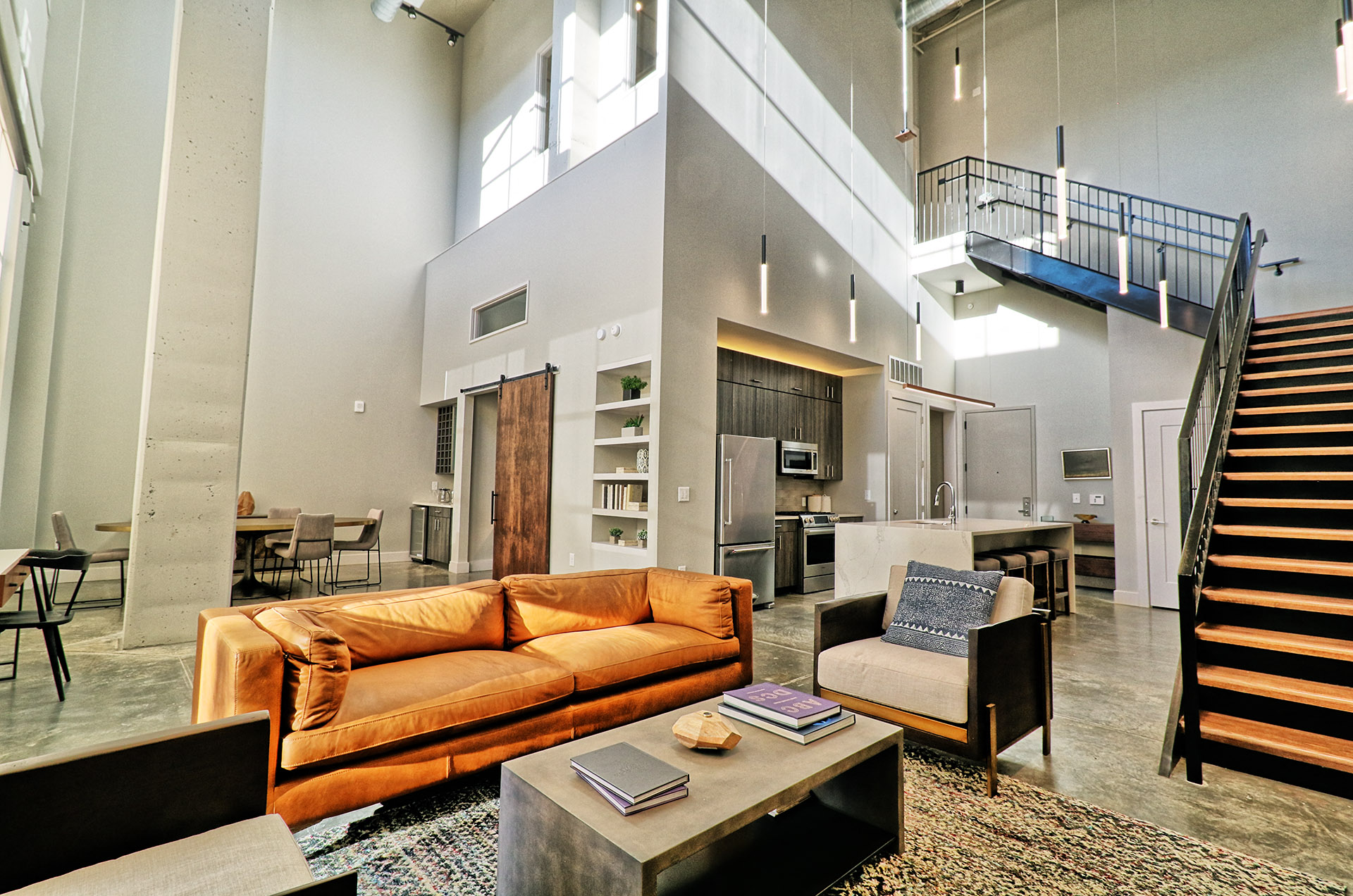 a large living room with a couch and a table